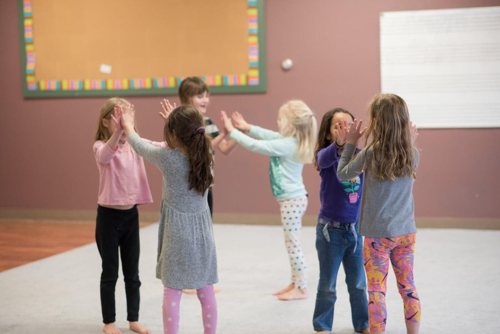 Children in group movement activities in a Dalcroze class